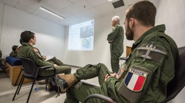 © C. VALVERDE/MN - Sur la base de Sigonella (Italie), l’équipage d’un ATL2 de la 21F est briefé par un officier britannique avant sa mission d’entraînement à la lutte anti-sous-marine.